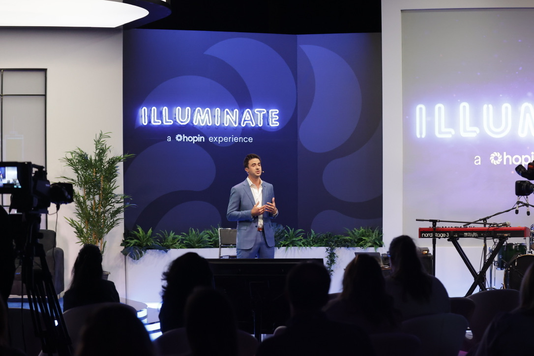Anthony Kennada speaking on stage at Hopin Illuminate